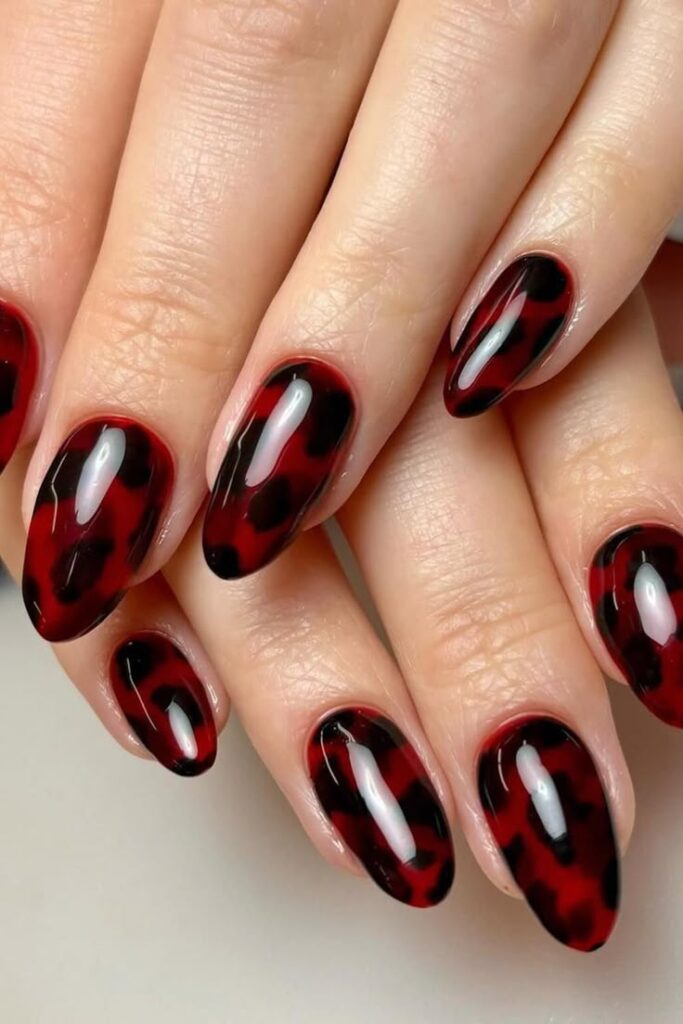 Black accents on a cherry red base nails