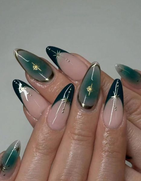 dark emerald nails fading into a shimmering silver glitter 